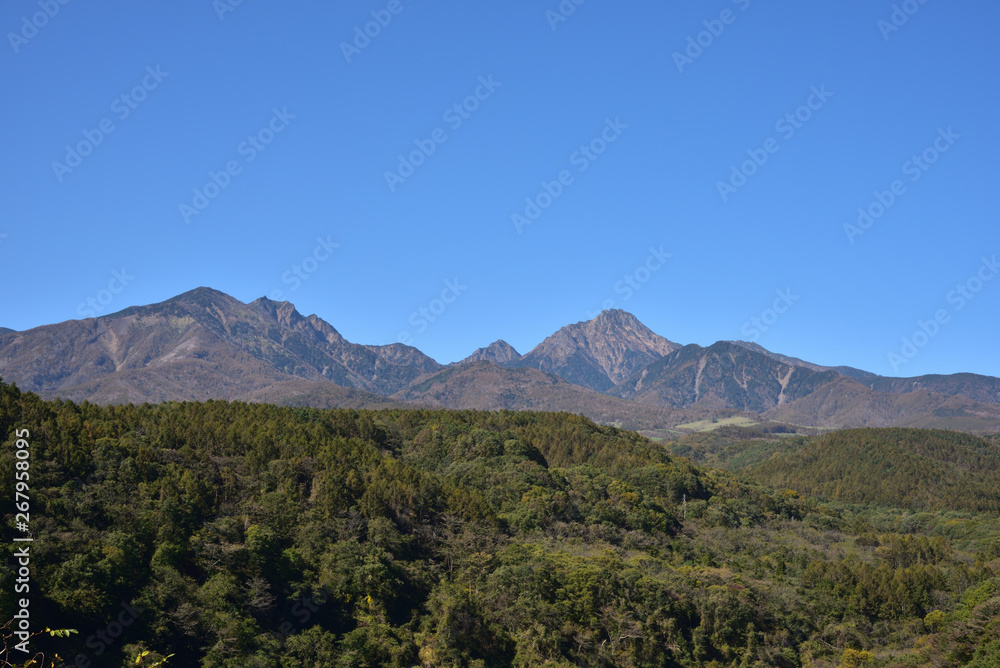 Fototapeta premium Mountains with red leaves and blue sky