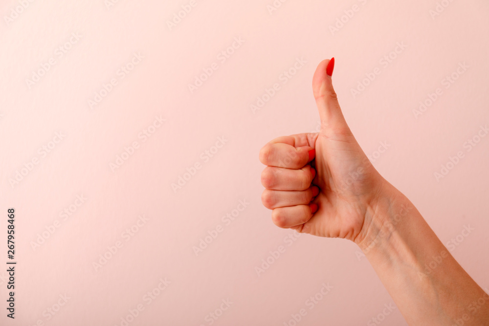 Closeup woman's hand isolated on pink background.