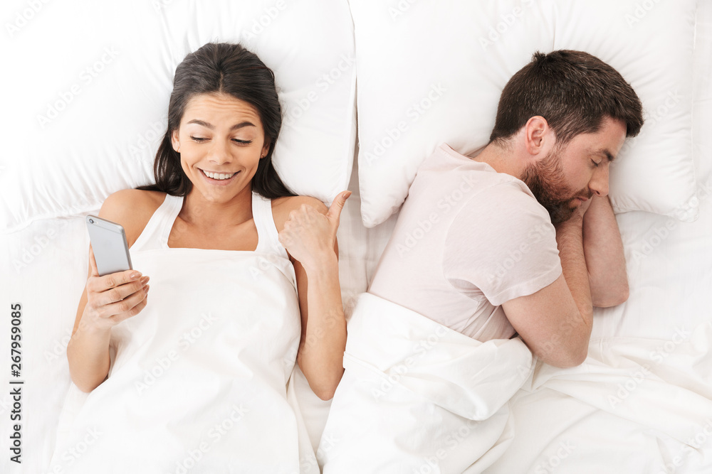 Portrait of a beautiful young couple laying in bed Portrait of a beautiful young couple laying in bed