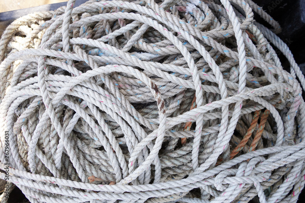 coils of used and grungy nylon white lobster trap rope Horizontal