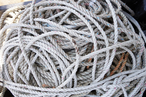 coils of used and grungy nylon white lobster trap rope Horizontal