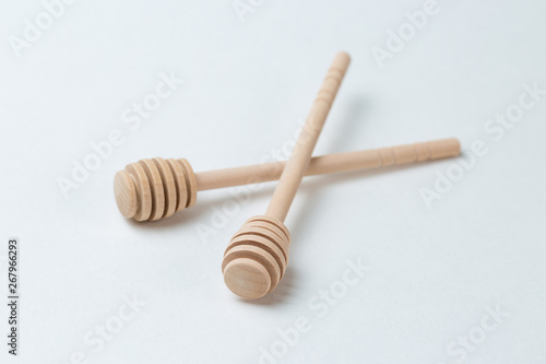 Wooden sticks for honey on a white background