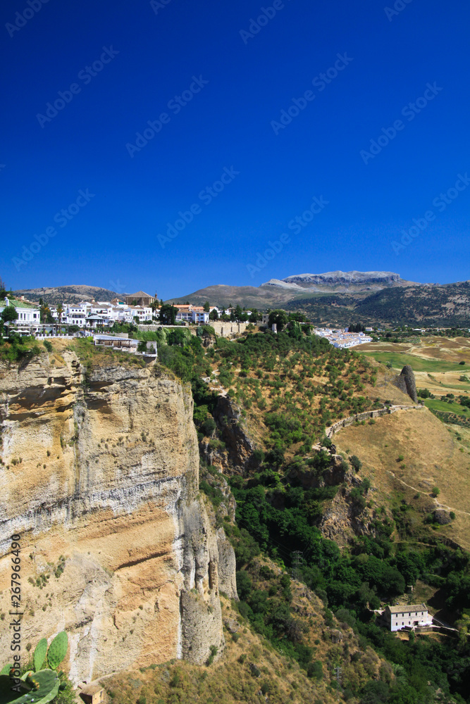 View on ancient village Ronda located precariously close to the edge of a cliff in Andalusia, Spain