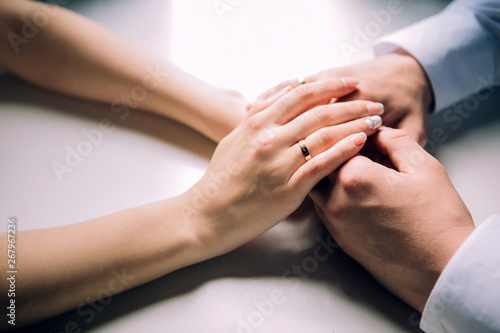 male hands are holding female hands. female hand with a wedding ring. reliable male hands. strong male hands. © Stanislav