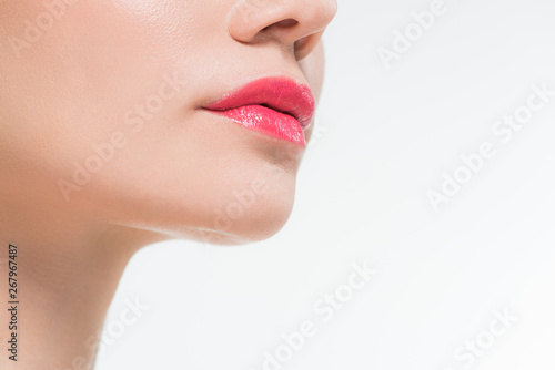 cropped view of young woman with pink lips isolated on white