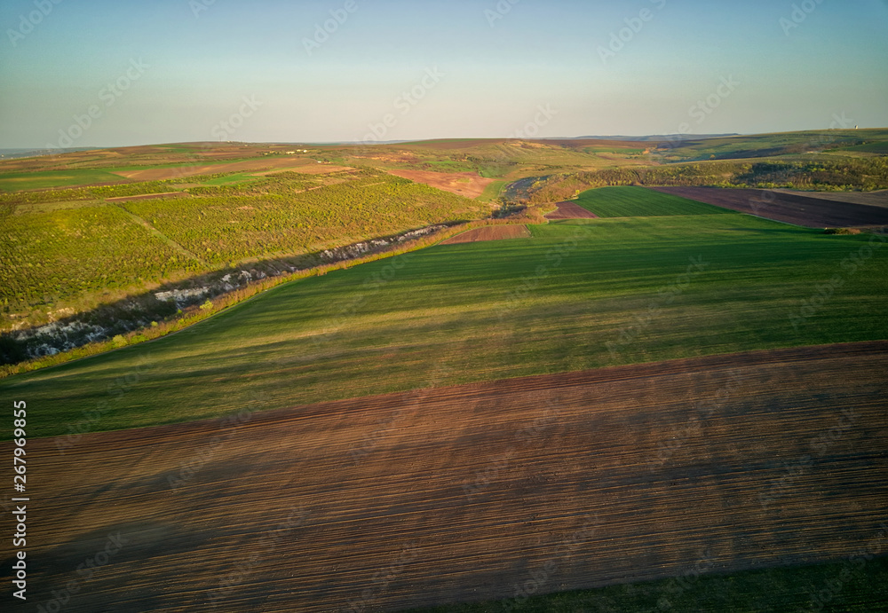 Sunset light over cultivating field in the spring