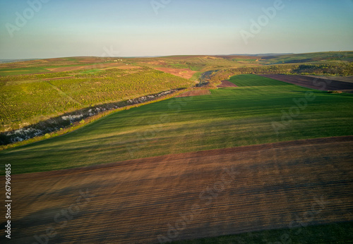 Sunset light over cultivating field in the spring