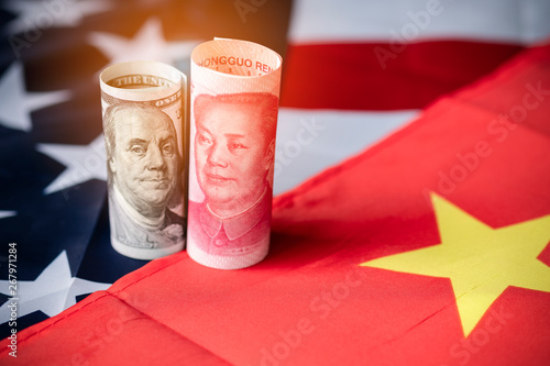Photography US dollar and Yuan banknote on USA and China flags