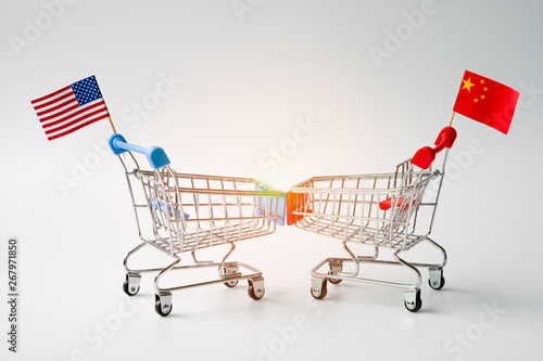 Closeup shopping cart with USA and China flag for tariff trade war between United States and China which both countries battle by increase tax barrier of import and export product. © Dilok