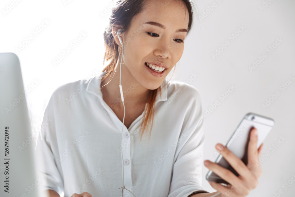 Attractive young asian businesswoman sitting at the office Attractive young asian businesswoman sitting at the office
