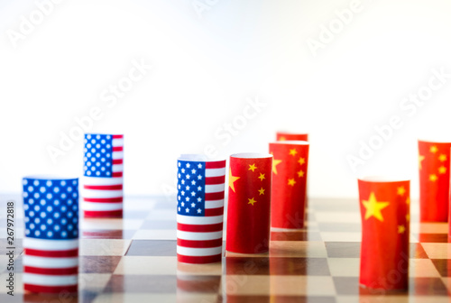 USA flag and China flag on chess board for tariff trade war between United States and China who conflict because of both increase tax barrier of import and export product. Government and business.