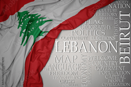 waving colorful national flag of lebanon on a gray background with important words about country photo