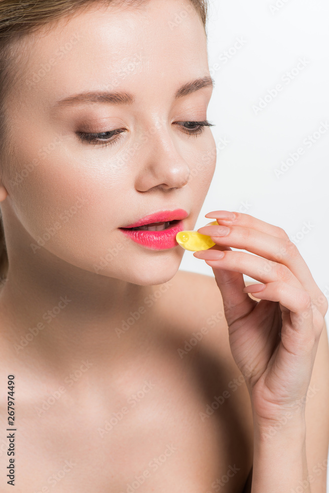 attractive nude woman holding yellow jelly candy isolated on white attractive nude woman holding yellow jelly candy isolated on white