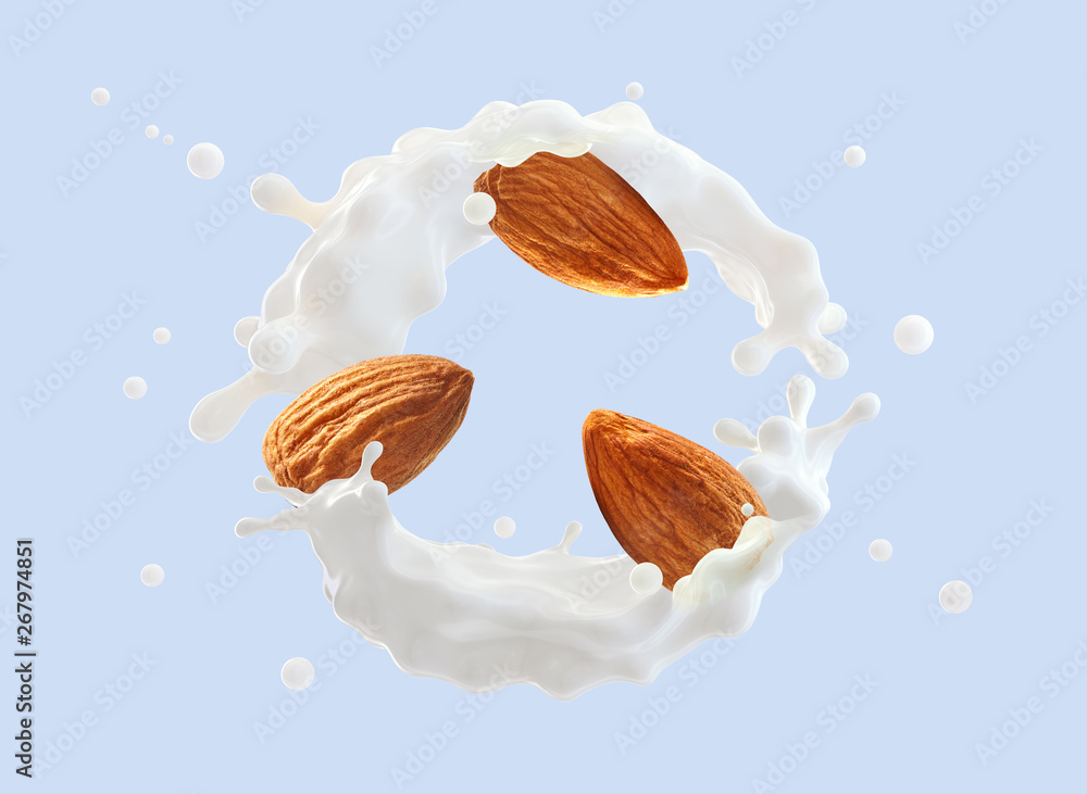 Fresh natural almond milk splash swirl with almonds isolated. Healthy