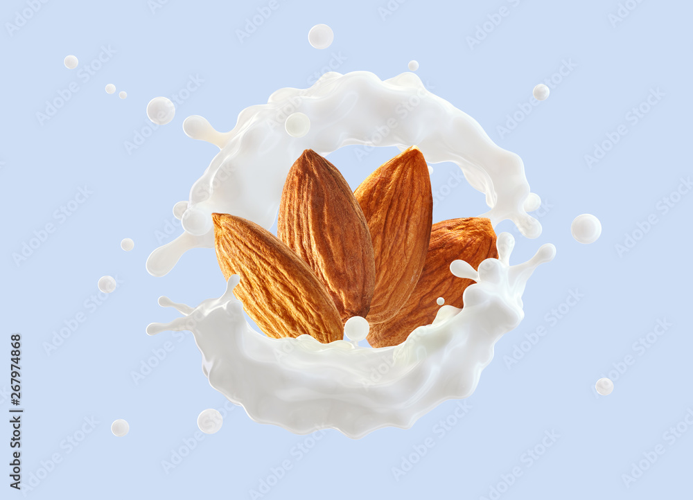 Fresh natural almond milk splash swirl with almonds isolated. Healthy