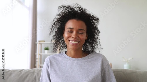 Smiling african woman skyping making video call looking at webcam photo