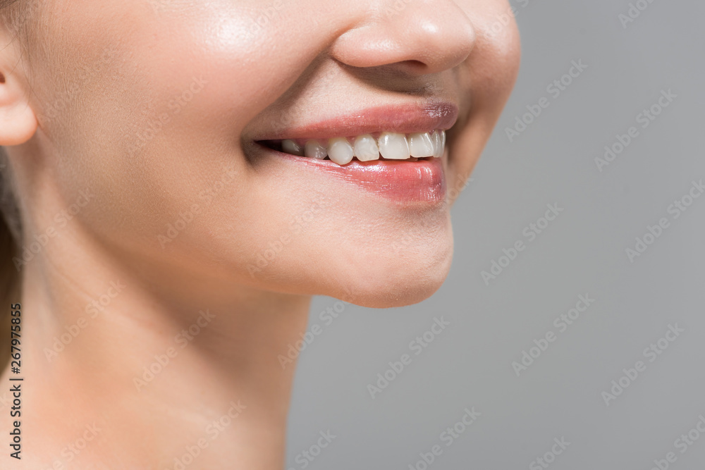 Obraz premium cropped view of cheerful woman smiling isolated on grey