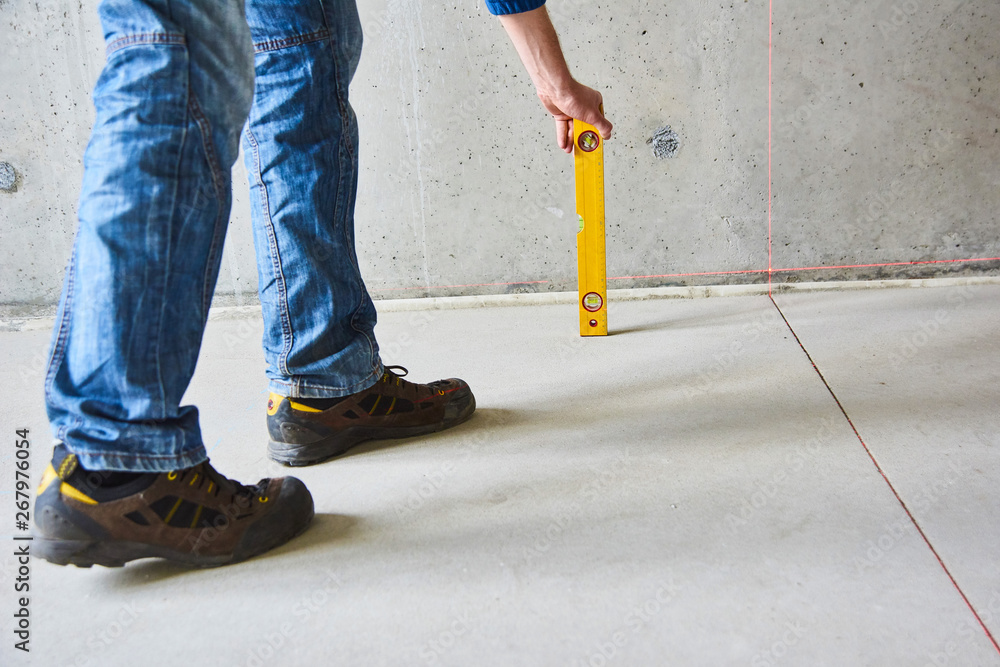 The worker control works of walls using laser line level. Laser roulette device The worker control works of walls using laser line level. Laser roulette device