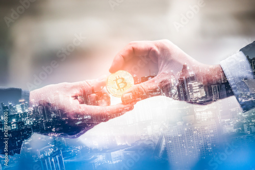 Double exposure of business give and bitcoin the new virtual electronic money with blur city night, investment concep photo