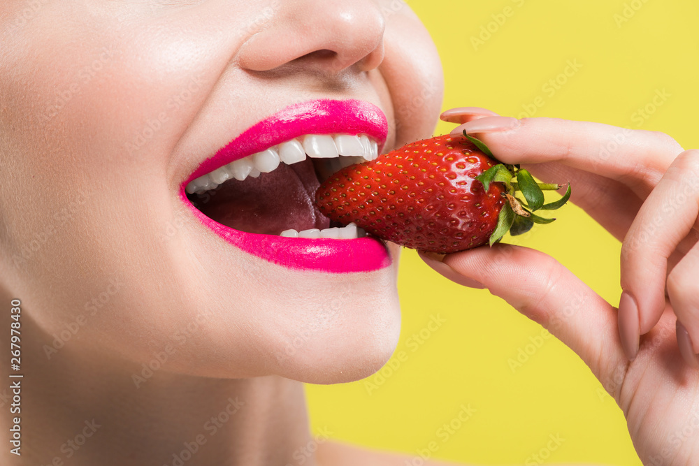 cropped view of happy woman eating tasty strawberry isolated on yellow cropped view of happy woman eating tasty strawberry isolated on yellow