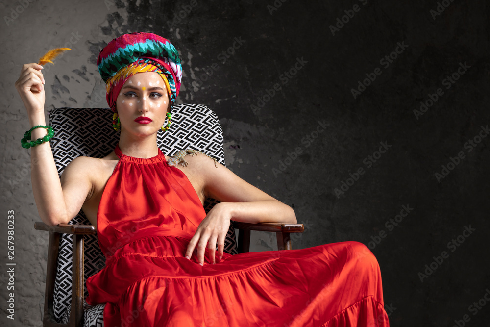 Φωτογραφία model in red dress and Oriental style of sitting in the chair Studio