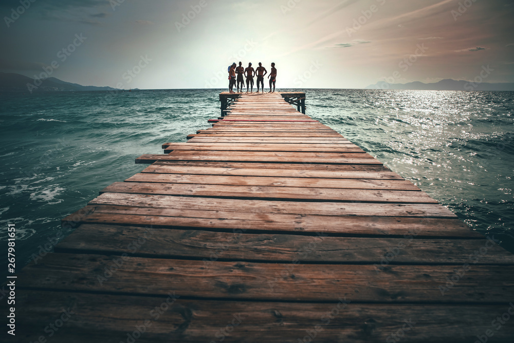 Naklejka premium A group of triathlon athletes on the pier after training
