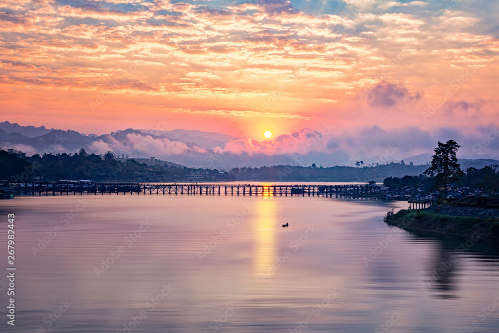 sunrise or morning light. Mon Bridge is the long wooden bridge. Official name is Attanusorn Bridge. Fishermen in Mon village, Sangkhla Buri, Kanchanaburi, Thailand 24 Jan 2019