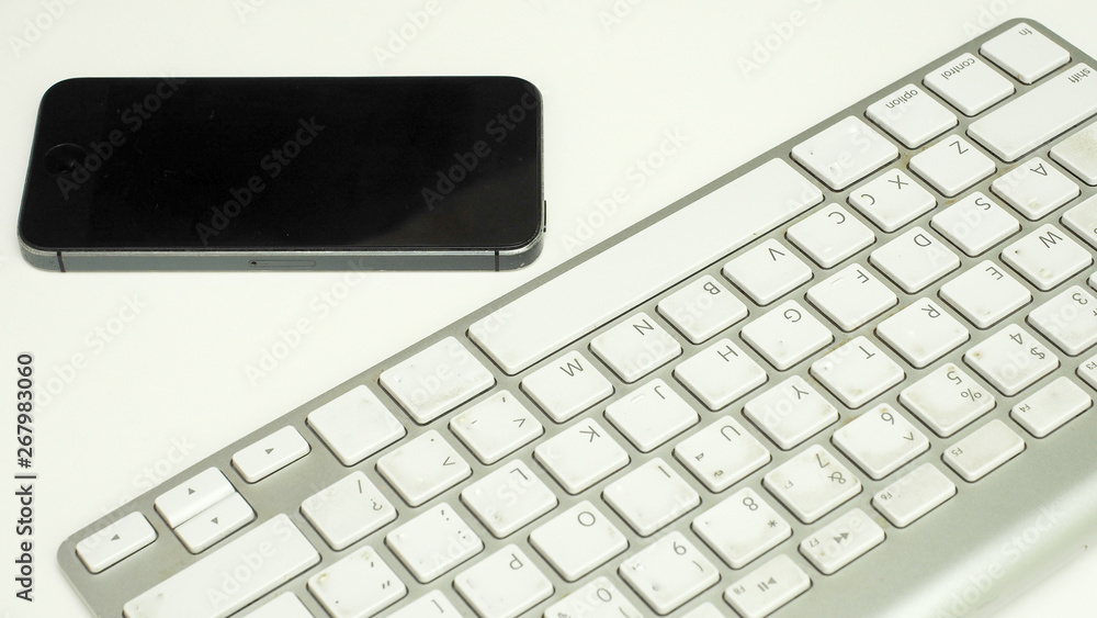 keyboard with smart phone on white background