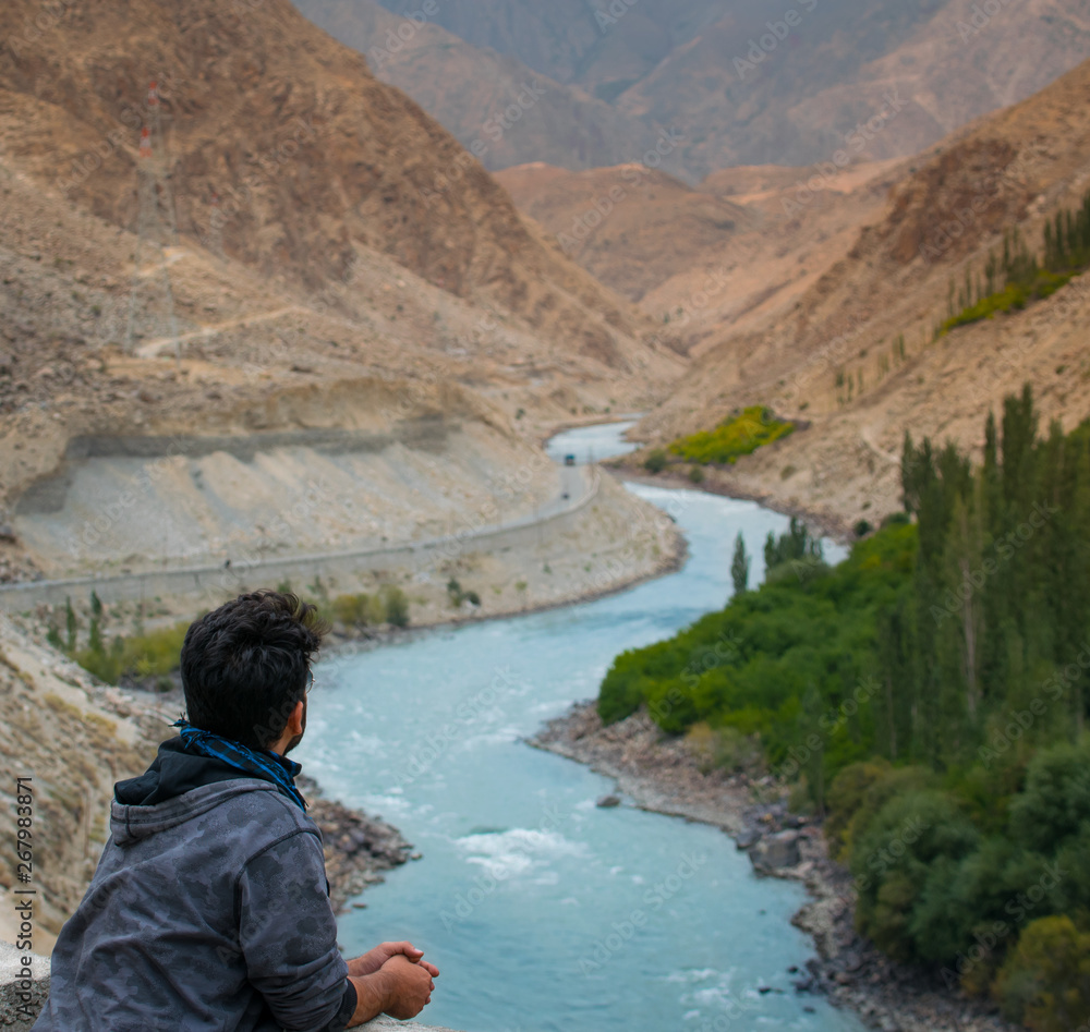 Man looking at blue river