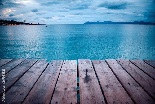 Dark morning by the sea. Pier in storm. Solitude  Loneliness concept photo