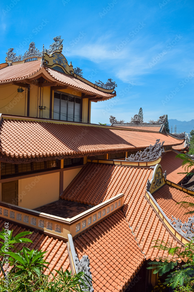Tile red roof of asian temple with window on sunny day in Long Son Pagoda in Nha Trang Tile red roof of asian temple with window on sunny day in Long Son Pagoda in Nha Trang