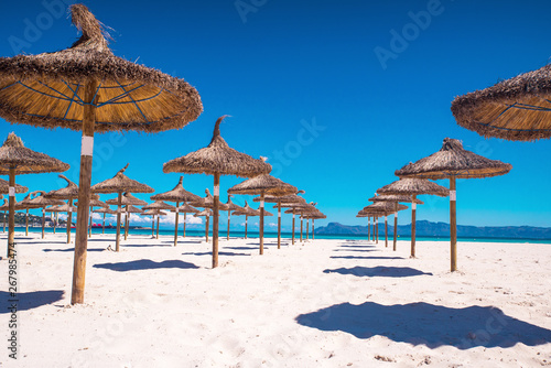 Beach sunbeds and parasols overlooking turquoise water