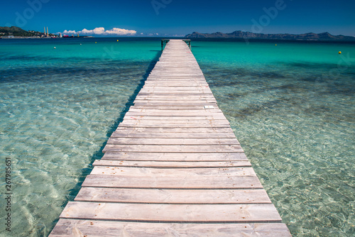 Pier on beautiful summer tropical beach. Holidays concept photo. Mallorca, Spain