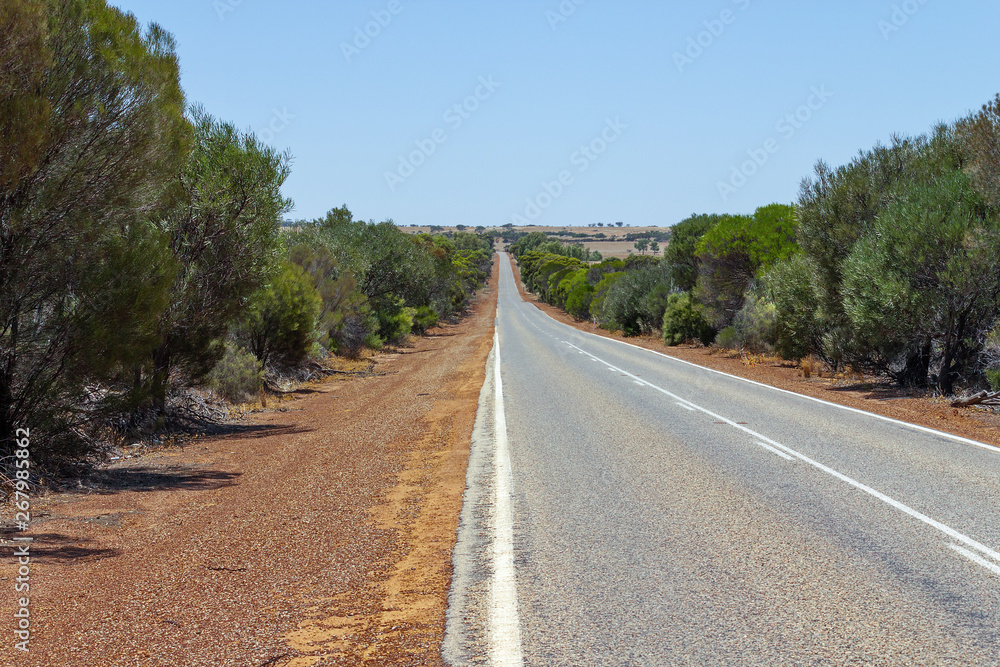 Natural scenery on the open road in Australian Outback.  Freedom and orange red road.