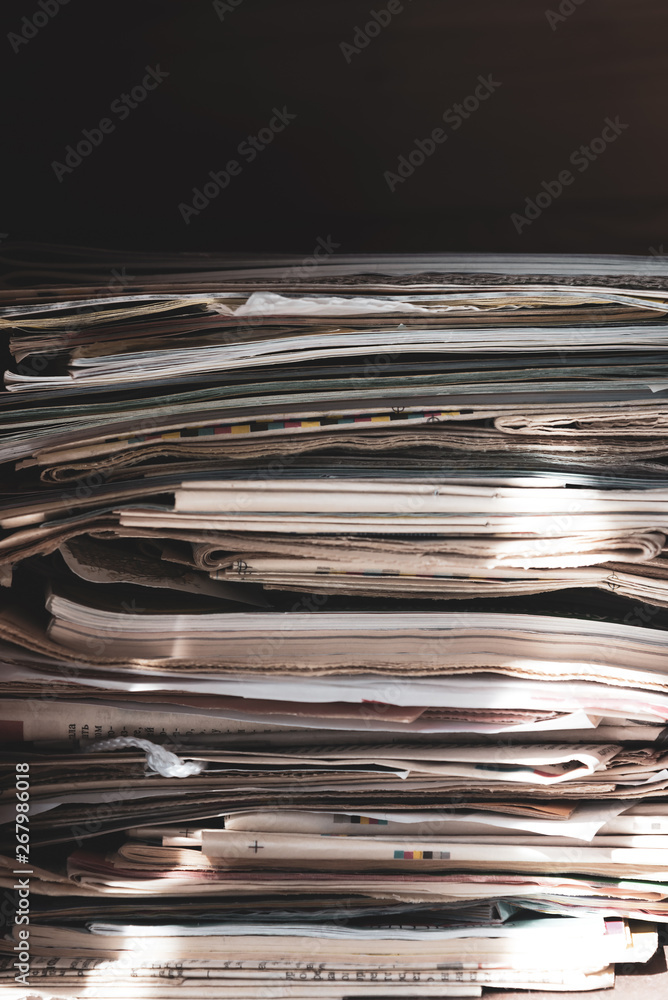 Pile of old newspapers and magazines, stack, side view. Vintage background Pile of old newspapers and magazines, stack, side view. Vintage background