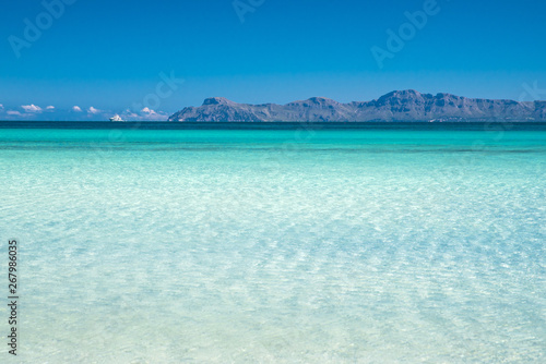 Beautiful clear blue tropical sea. Summer vacation, holiday concept photo. Playa de Muro, Spain
