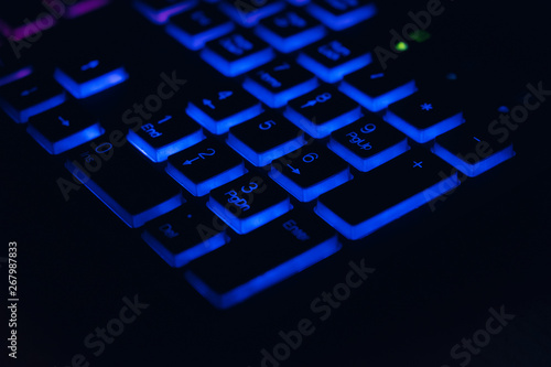 Closeup of laptop keyboard illumination, backlit keyboard photo