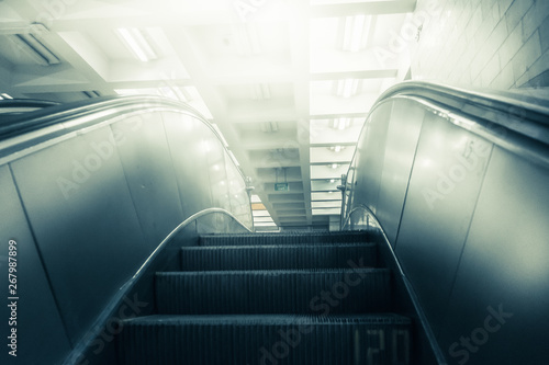 Concept of success in business, moving up the career path. Underground Escalator Conveor in Subway