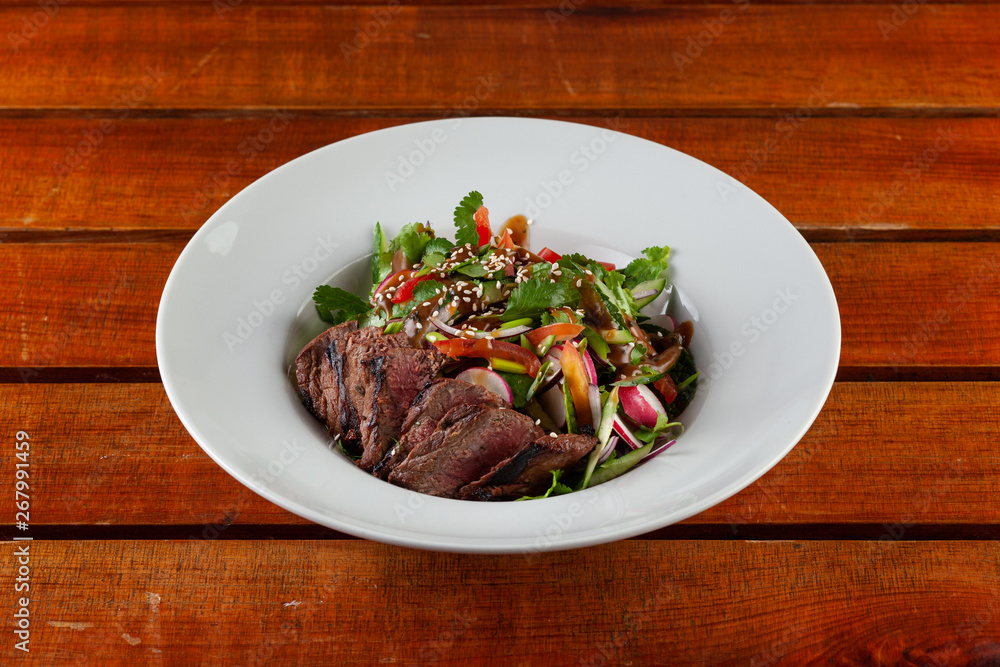 Top-view salad with medium rare beef steak Top-view salad with medium rare beef steak