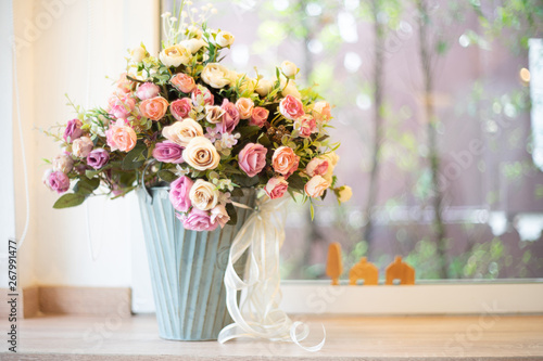 Artificial Flowers in white vase as background