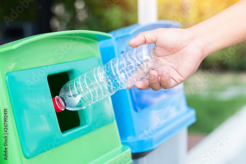 Save the world concept, Hand throw plastic bottle into recycle bin