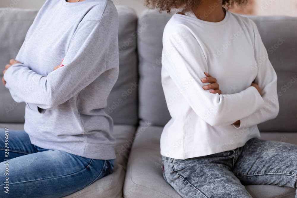 Close up African American mother and teen daughter after quarrel Close up African American mother and teen daughter after quarrel