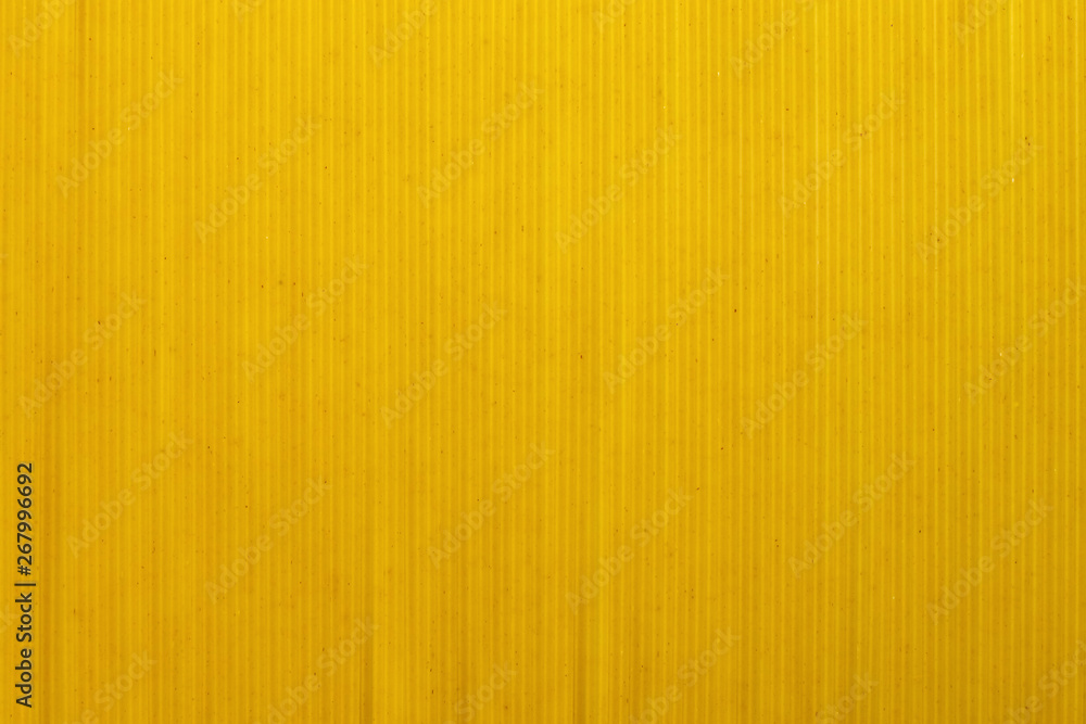 Yellow long spaghetti, top view. Thin pasta arranged in rows for the background. Yellow Italian pasta. Long spaghetti. Concept food background. Yellow long spaghetti, top view. Thin pasta arranged in rows for the background. Yellow Italian pasta. Long spaghetti. Concept food background.