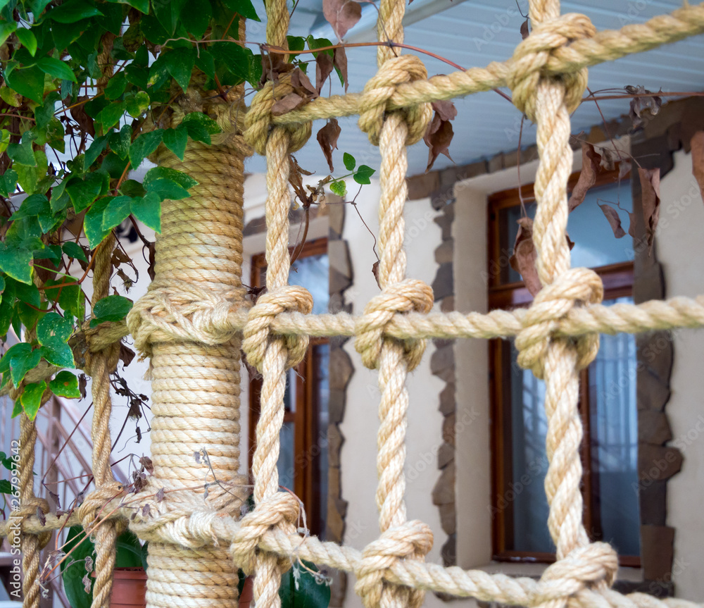 Grid of ropes as a frame for the veranda