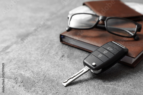 Composition with male accessories and car key on grey background. Space for text