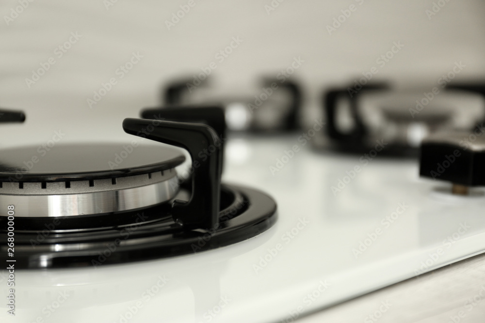 Modern built-in gas cooktop, closeup with space for text. Kitchen appliance Modern built-in gas cooktop, closeup with space for text. Kitchen appliance