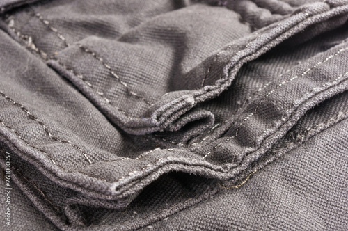 clothing items washed cotton fabric texture with seams, clasps, buttons and rivets