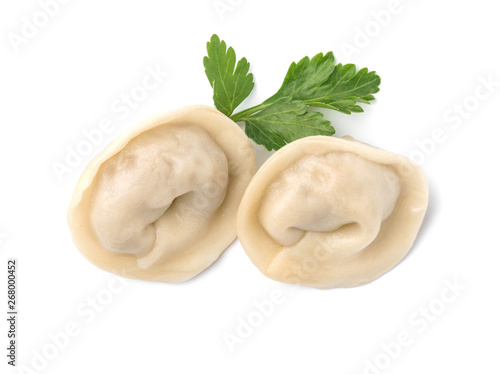 Fresh boiled dumplings and parsley leaf on white background, top view