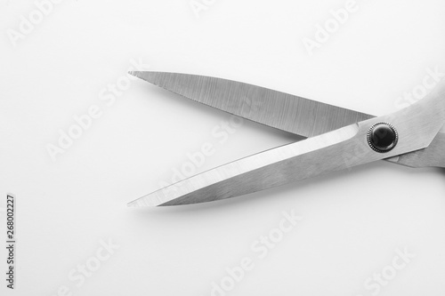 Pair of sharp sewing scissors on white background, closeup