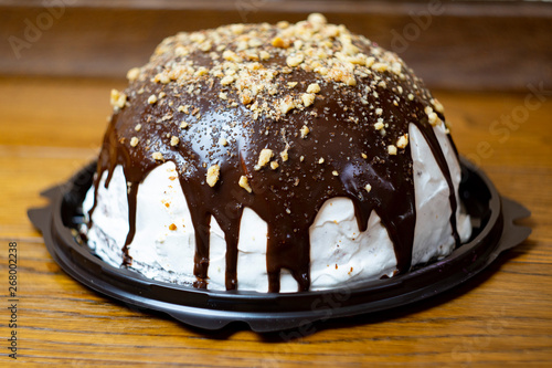 Close-up, delicious and appetizing souffle cake with chocolate sprinkled with nuts